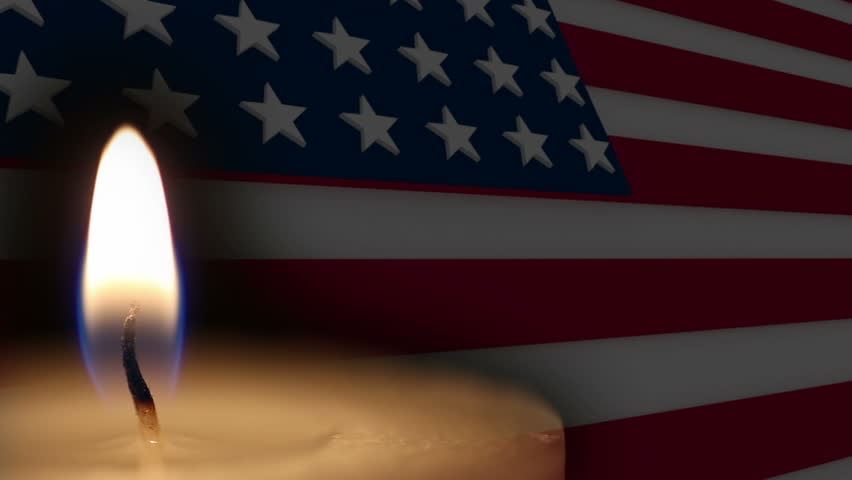American Flag with a burning candle